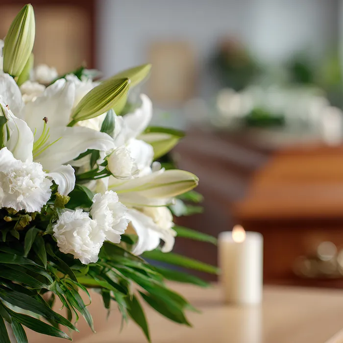 Blumen auf Tisch vor Sarg